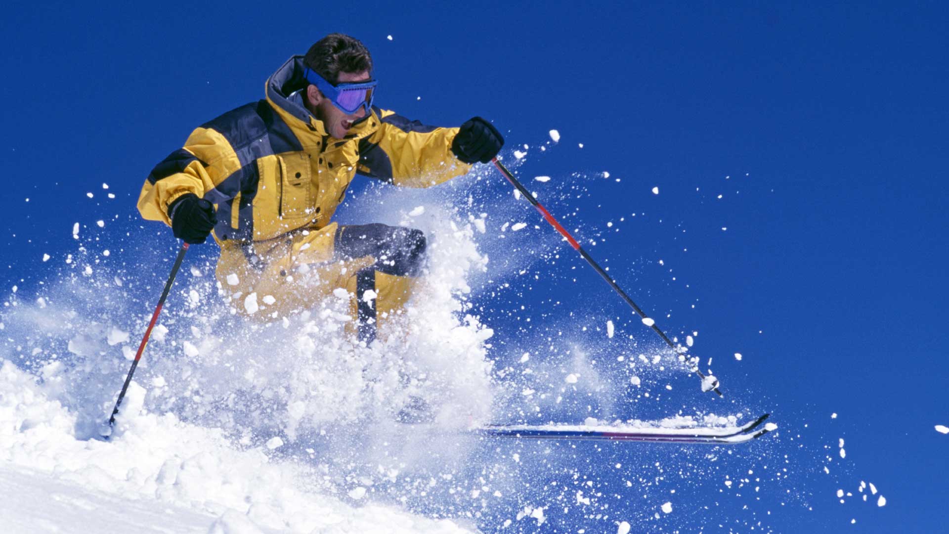 Downhill skier shredding powder on blue sky blog post cover for Understand Your Brand Marketing