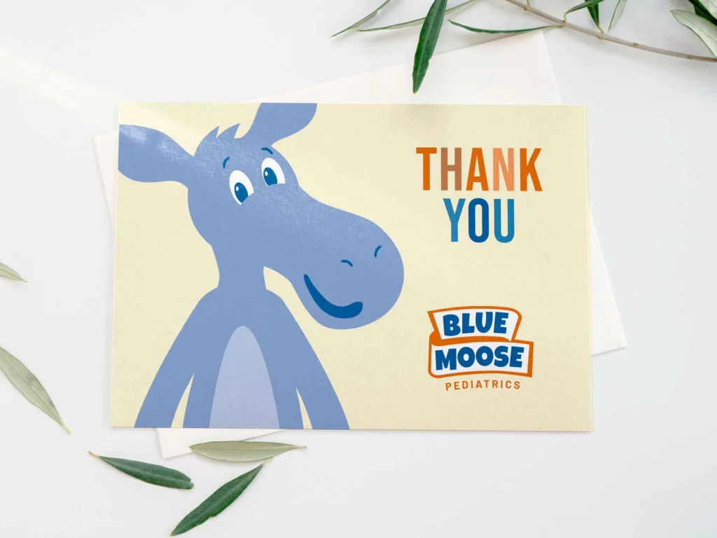 Thank you card design for Blue Moose Pediatrics on table with leaves